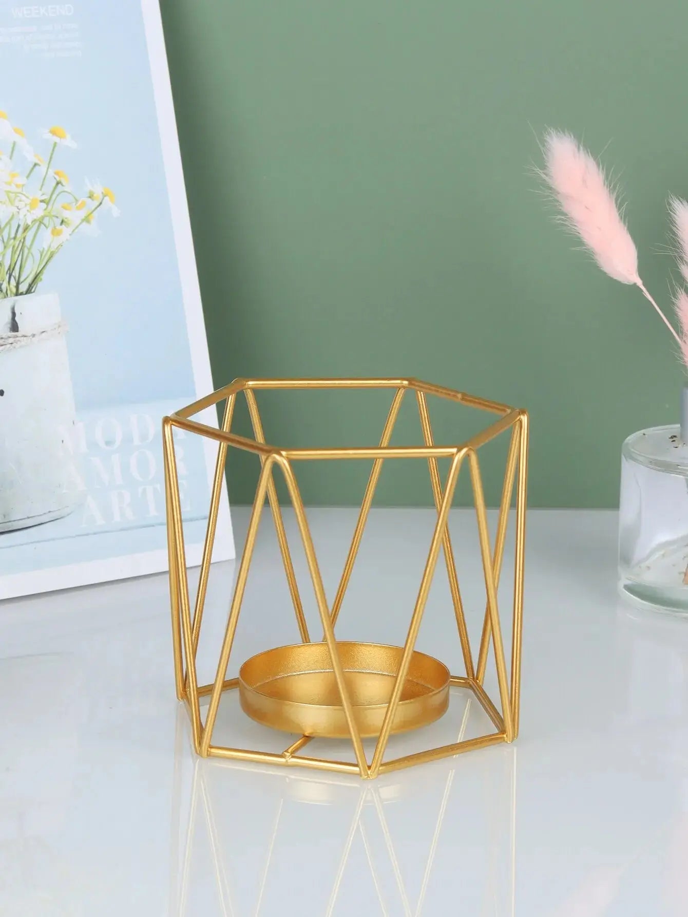 Pair of Nordic Gold Iron Candlesticks creating a warm and inviting ambiance in a minimalist living room.